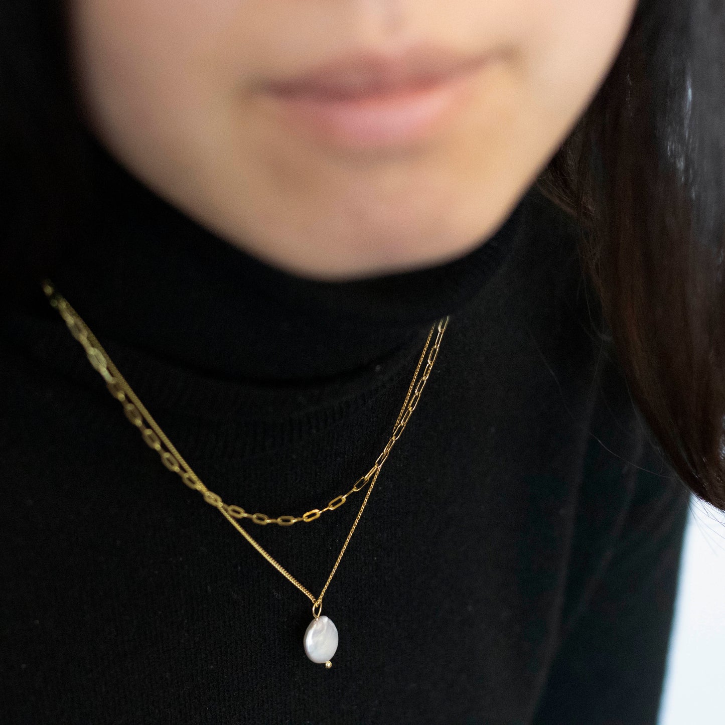 A sizable baroque pearl adorns the double beaded chain of this necklace.