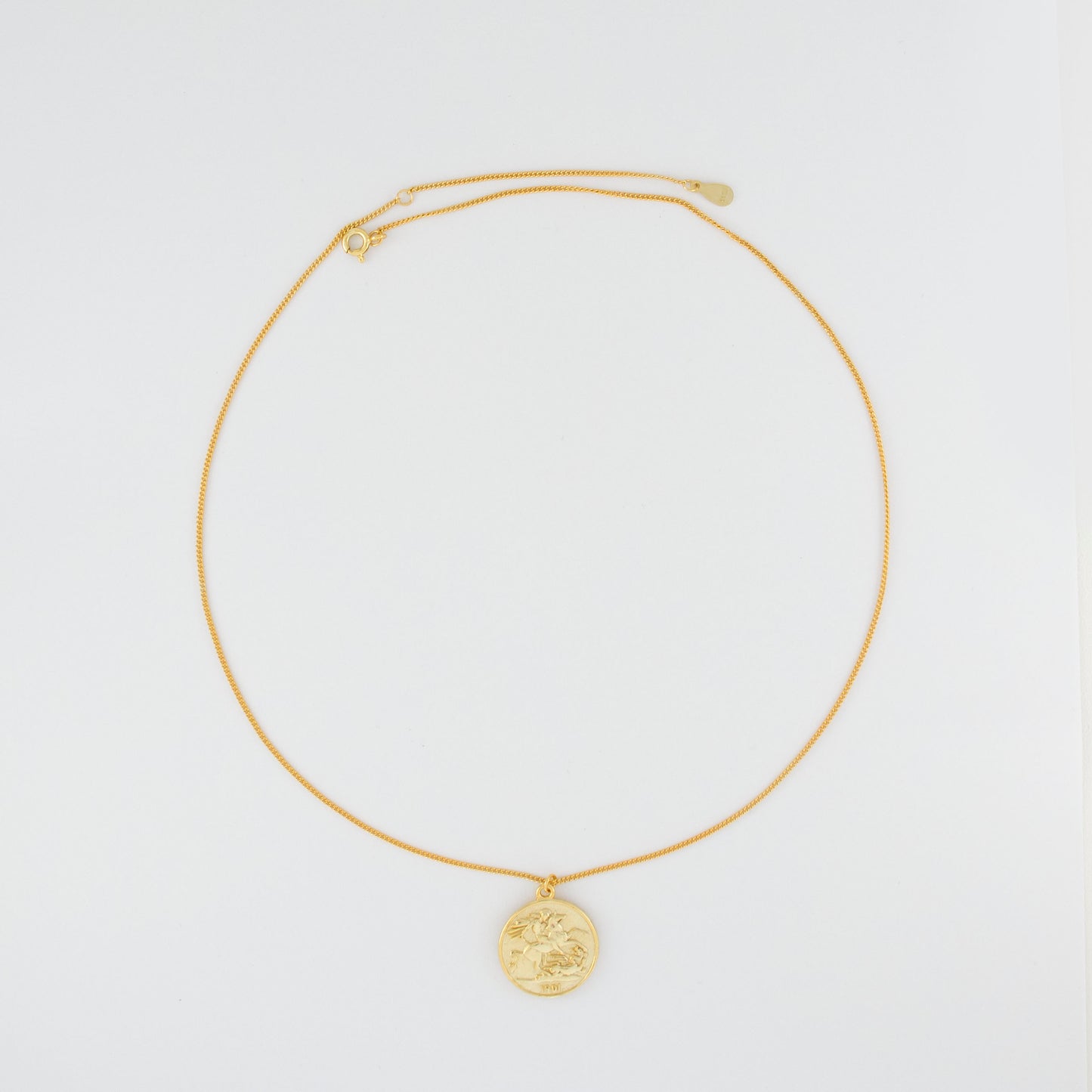 The necklace is adorned with a coin, layer with a relief of a queen and a flying horse on the reverse side.