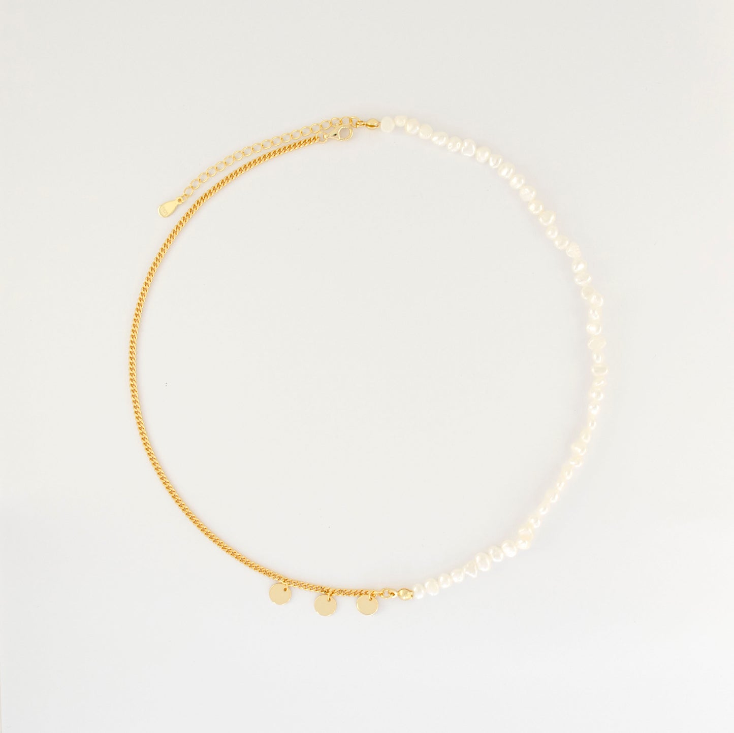 The double-layered necklace is adorned with rice pearl nuggets.