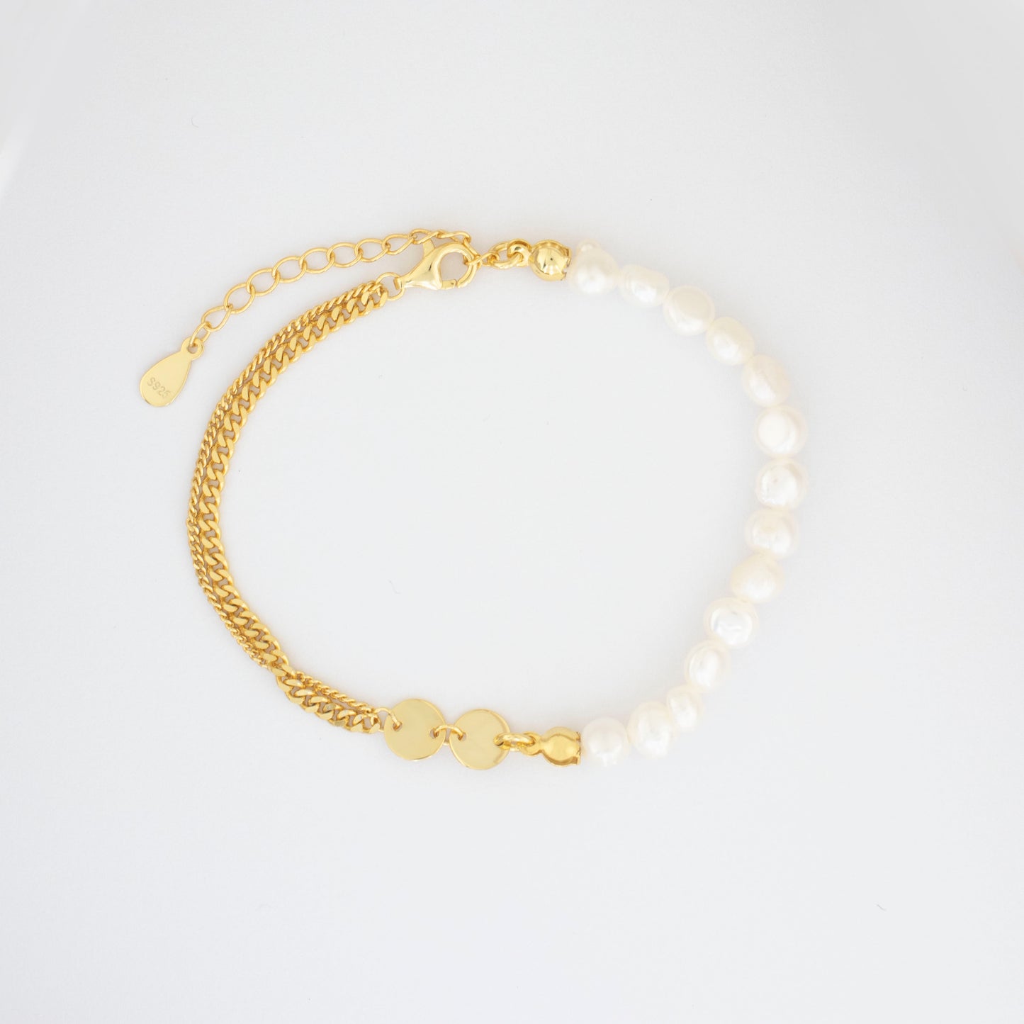 The double-layered bracelet is adorned with rice pearl nuggets.