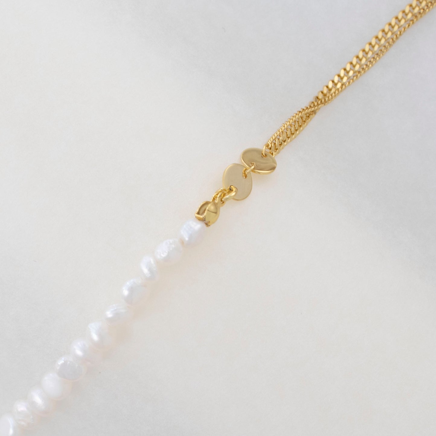 The double-layered bracelet is adorned with rice pearl nuggets.