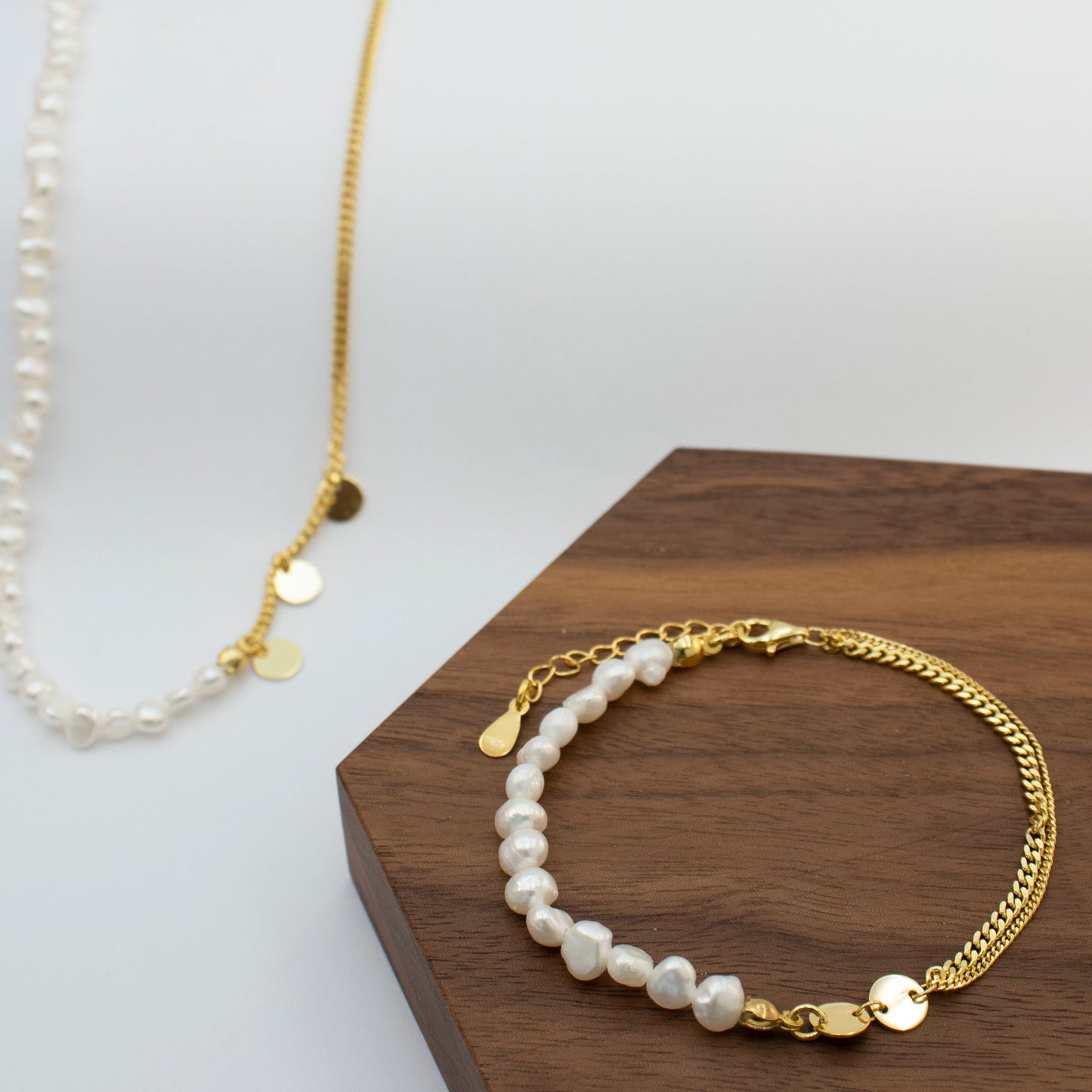 The double-layered bracelet is adorned with rice pearl nuggets.